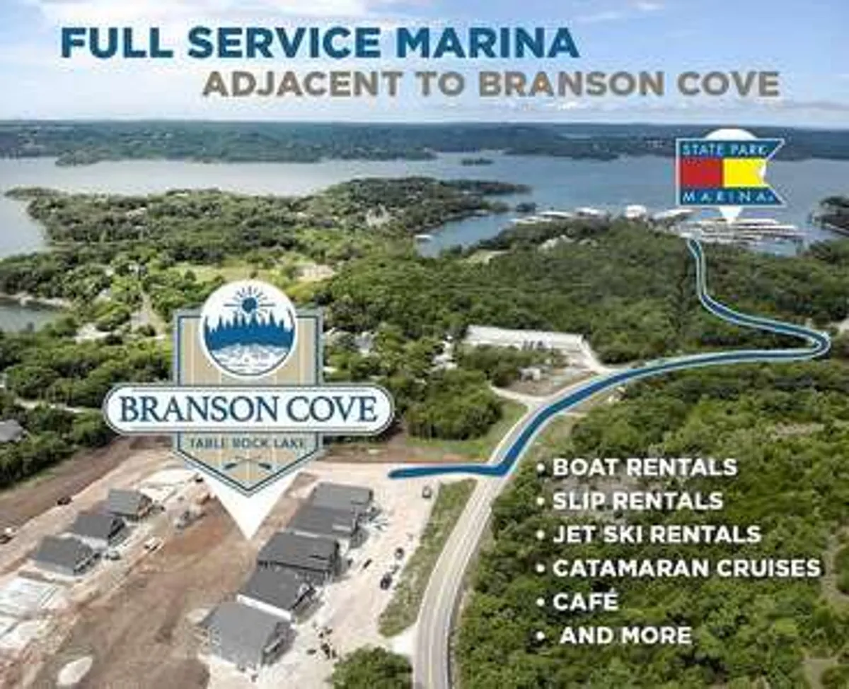 A lakeside marina scene showcasing the Branson Cove logo, marina facilities, sparkling water, and lush greenery. The setting is ideal for boating, dining, or simply soaking in the local ambiance, capturing the recreational spirit of the Branson area.