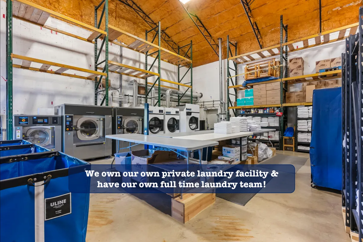 This interior shot highlights the resort’s commercial laundry facility, showcasing industrial washing machines, organized folding tables, and neatly arranged storage shelves. The scene expresses efficiency and attention to cleanliness.